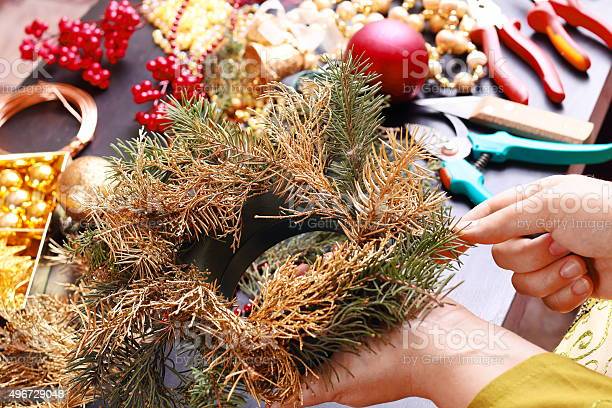 Woman making christmas advent wreath, close up